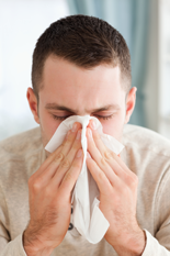 Man Sneezing Into Tissue