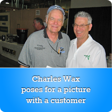 Charles Wax poses for a picture with a customer