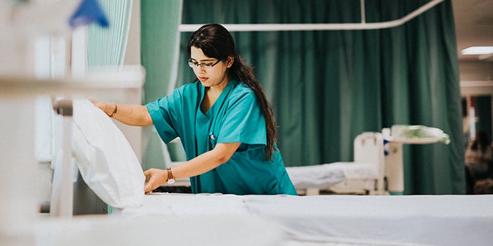 EVS-Housekeeping-Staff-at-a-Hospital-Remaking-Bed_1224308947_700x350