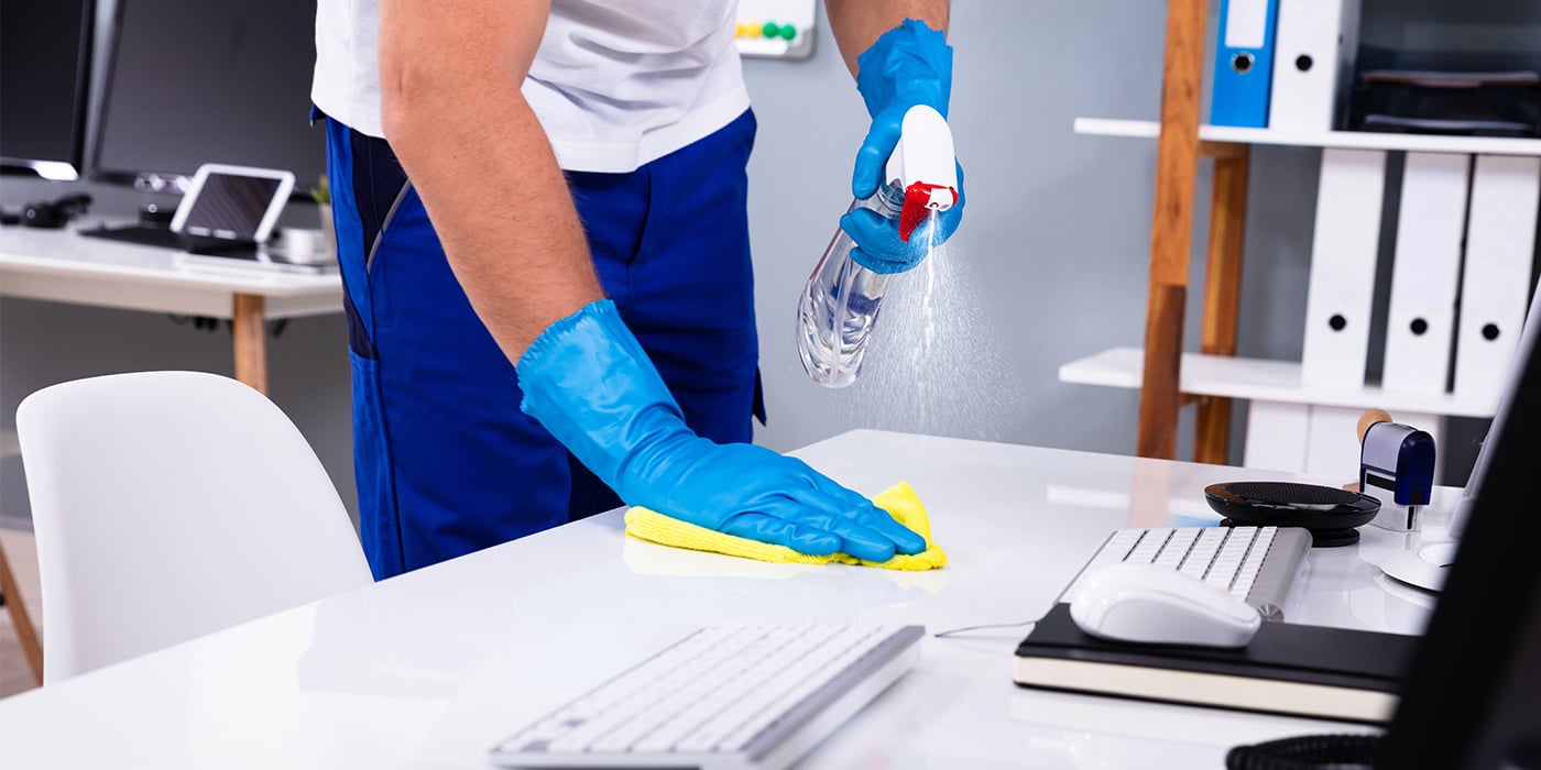 Janitor-Cleaning-&-Disinfecting-Office-Desk_1401013190_1400x700