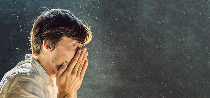 Man-Surrounded-by-Dust-Sneezing_1248336166_700x329